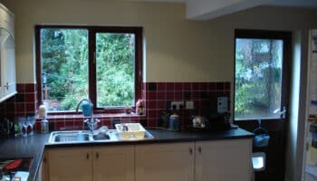 kitchen with red wall tiles