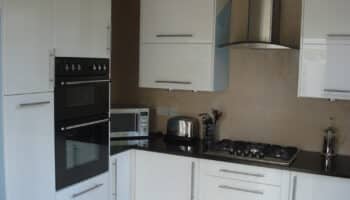 completed kitchen conversion with glossy white fixtures