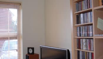 garage conversion with blinds, clock and a tv