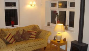 garage conversion with yellow sofa