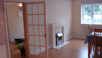 garage conversion with fireplace and table