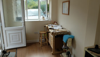 garage conversion with cream walls and work desk